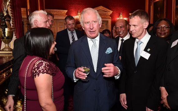 Prince Charles looks suave in a pin stripe suit as he hosts The National Pharmacy Association reception